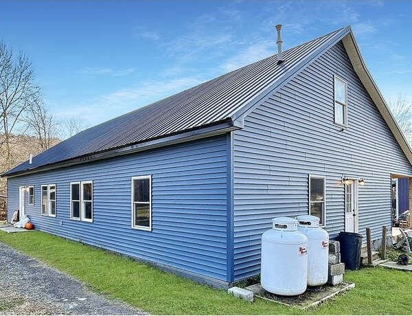 view of side of home featuring a lawn