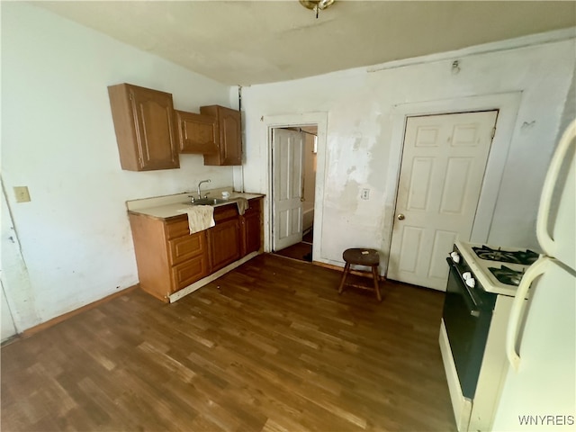 kitchen featuring gas range gas stove and dark hardwood / wood-style flooring