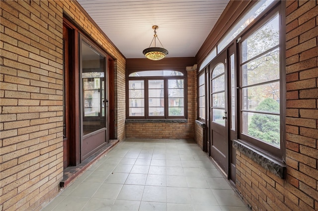 unfurnished sunroom featuring plenty of natural light