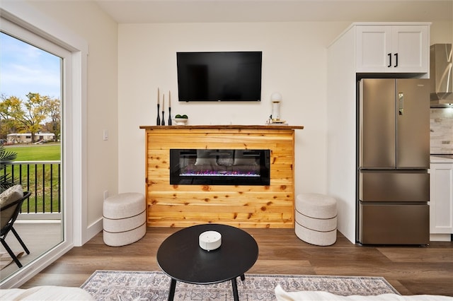 living room featuring a wealth of natural light and hardwood / wood-style flooring