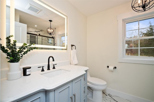 bathroom featuring vanity, a chandelier, an enclosed shower, and toilet