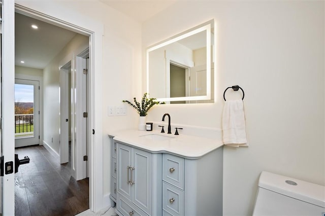 bathroom featuring hardwood / wood-style floors, vanity, and toilet