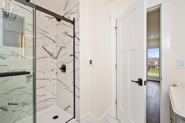 bathroom featuring a shower with door