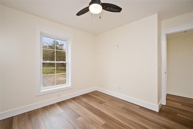 unfurnished room with ceiling fan and hardwood / wood-style floors