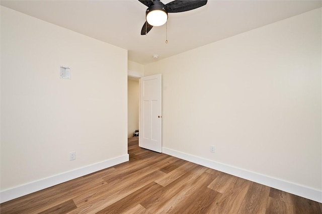 spare room with ceiling fan and light wood-type flooring