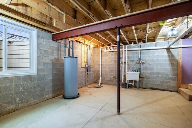 basement with electric panel, gas water heater, and sink