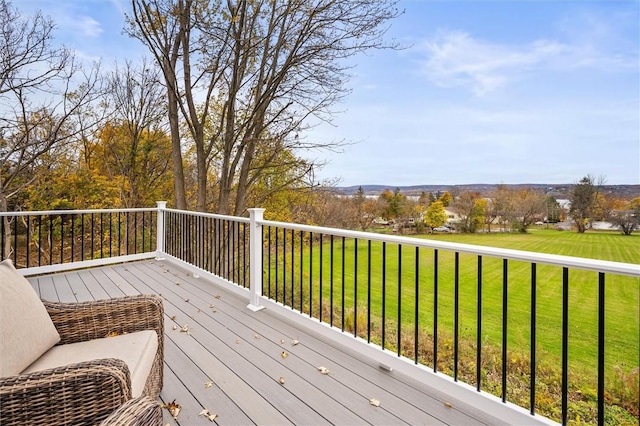 wooden deck featuring a lawn