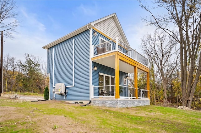 rear view of property with a lawn