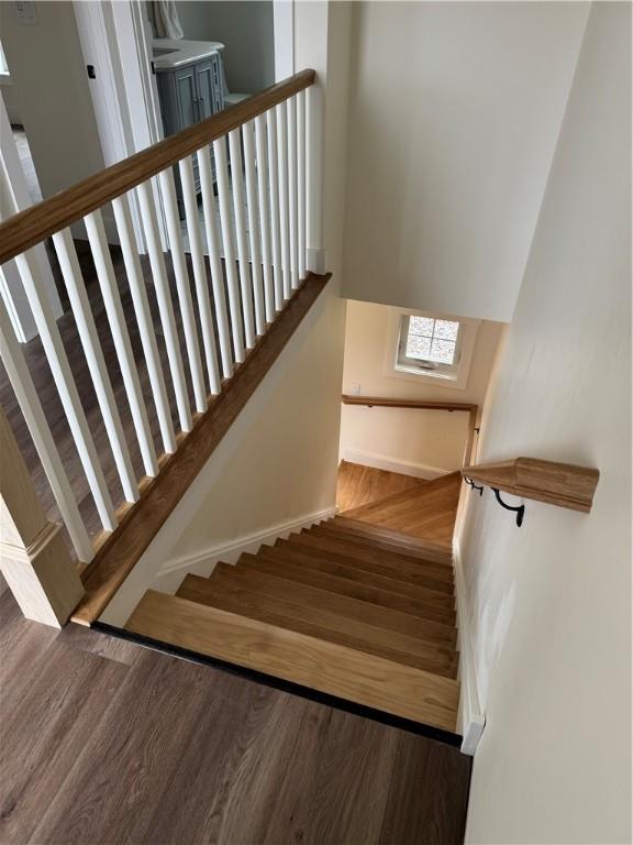 stairs with hardwood / wood-style floors