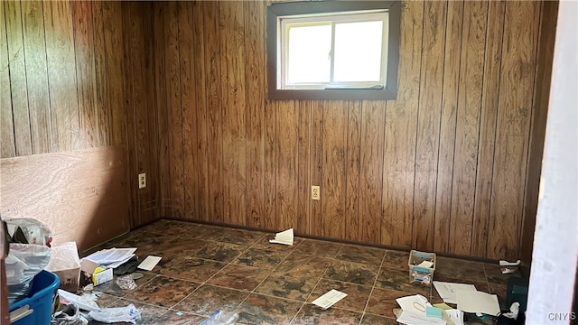 spare room featuring wooden walls