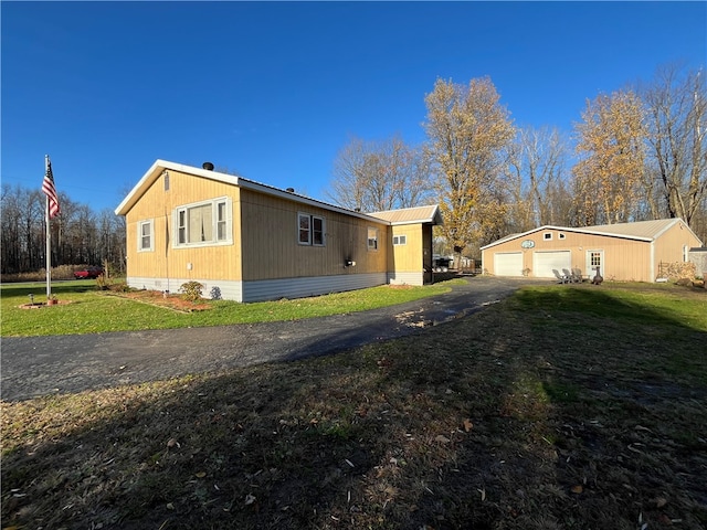 view of property exterior with a lawn and a garage