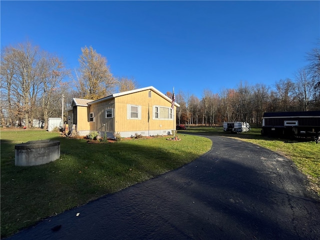 view of property exterior with a lawn