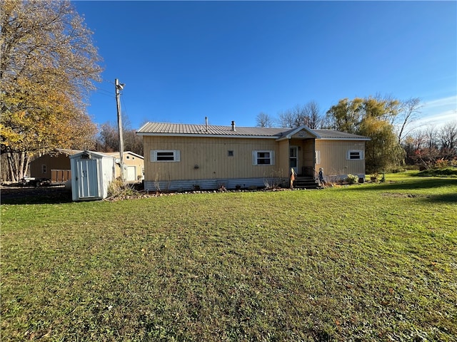 back of property featuring a yard and a storage shed