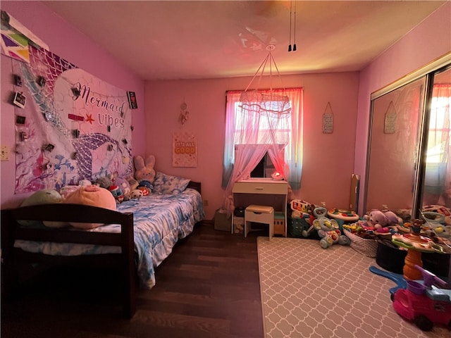 bedroom featuring dark wood-type flooring and a closet