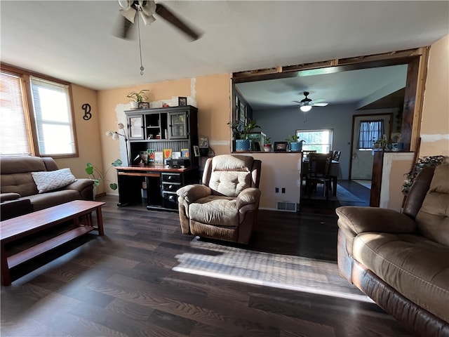 living room featuring dark wood-type flooring, ceiling fan, and lofted ceiling