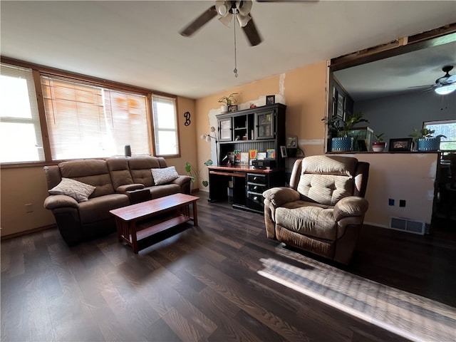 living room with dark hardwood / wood-style flooring and ceiling fan