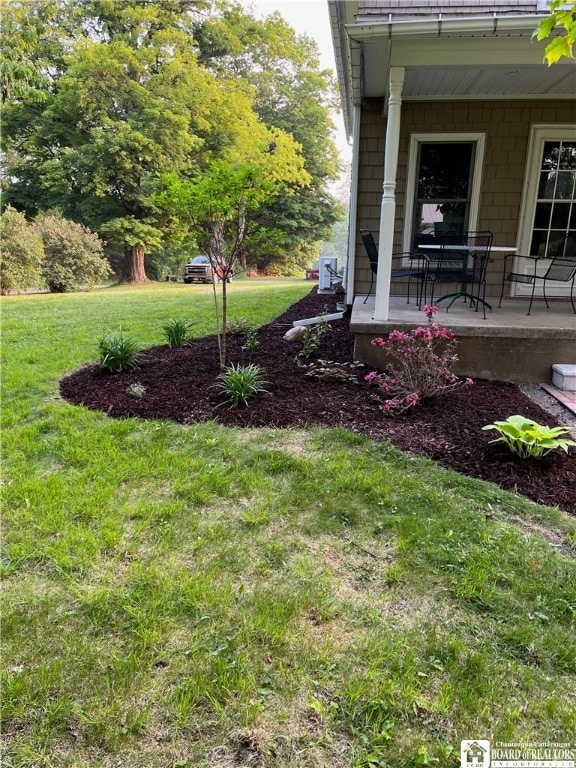 view of yard with covered porch