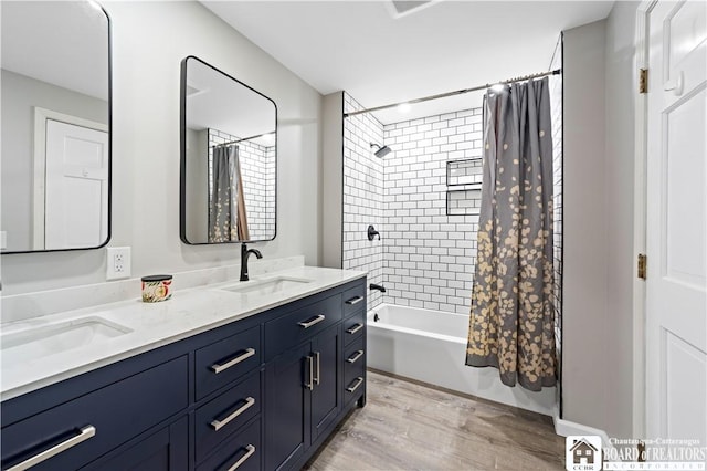 bathroom featuring vanity, shower / bathtub combination with curtain, and wood-type flooring