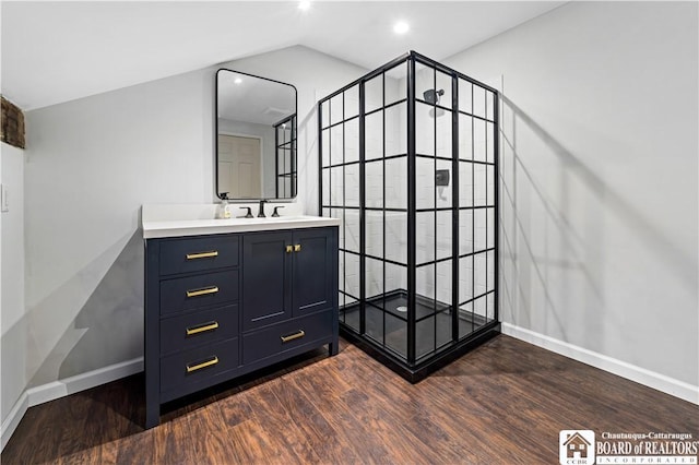 bathroom featuring sink, wood-type flooring, and lofted ceiling