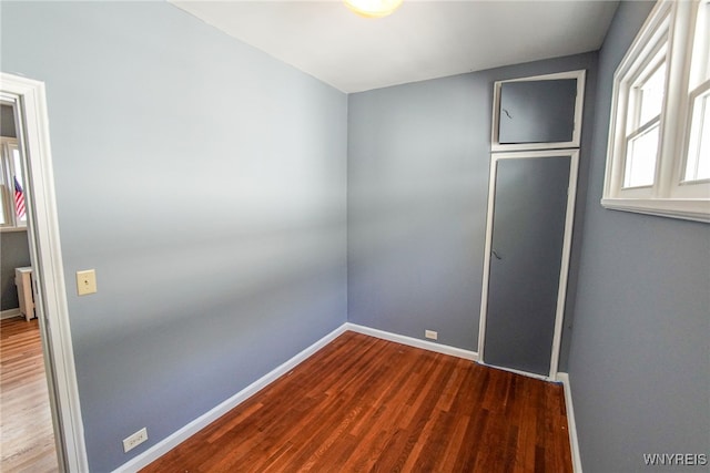 spare room featuring wood-type flooring