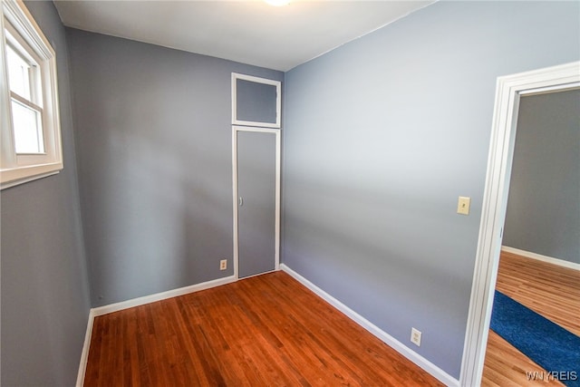 unfurnished room with hardwood / wood-style flooring