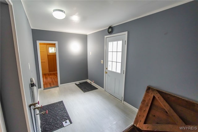 doorway to outside featuring light hardwood / wood-style floors and crown molding