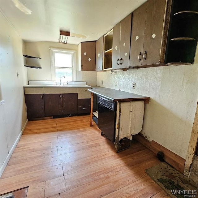 kitchen featuring dishwasher, light hardwood / wood-style flooring, tasteful backsplash, and dark brown cabinets