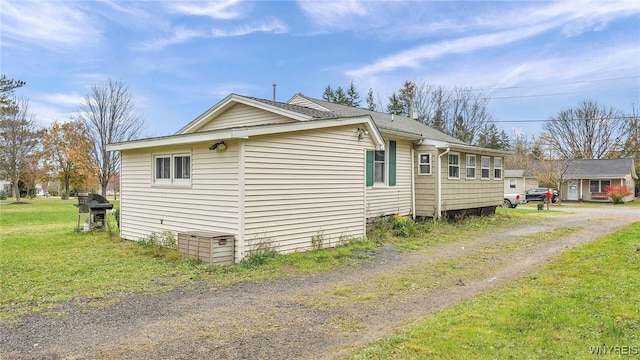 view of side of property with a yard