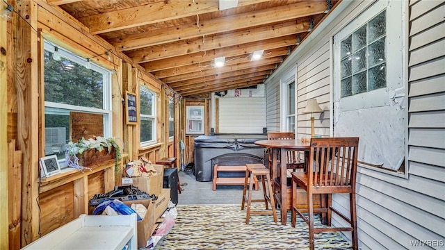 sunroom with lofted ceiling with beams and wood ceiling