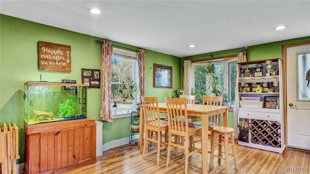 dining area with light hardwood / wood-style floors and radiator