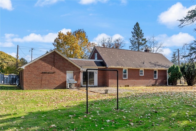 back of property featuring a yard