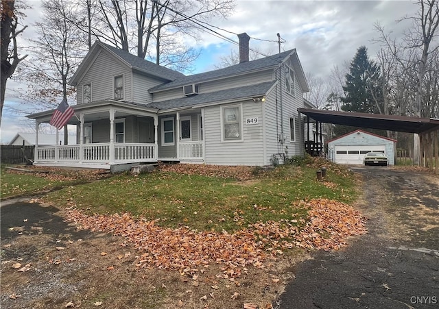 view of front of house featuring a garage, a porch, a carport, an outdoor structure, and a front lawn