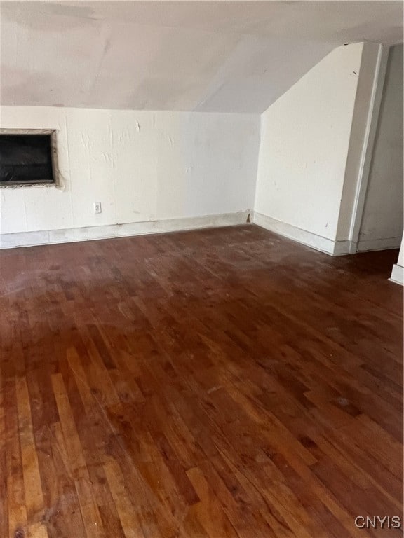 bonus room featuring dark hardwood / wood-style flooring and vaulted ceiling