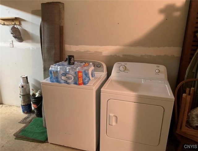 clothes washing area with washing machine and dryer