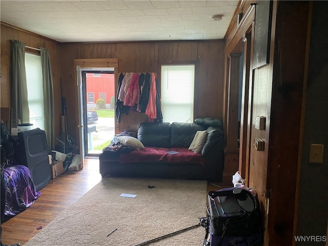 living room featuring hardwood / wood-style floors and wooden walls