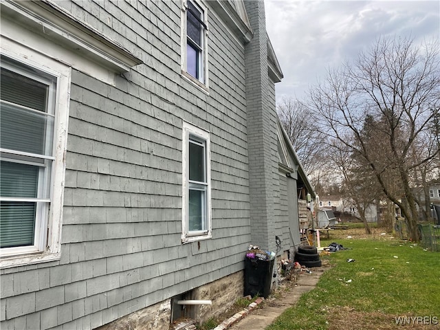 view of side of property with a yard