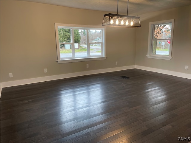 spare room with dark hardwood / wood-style flooring