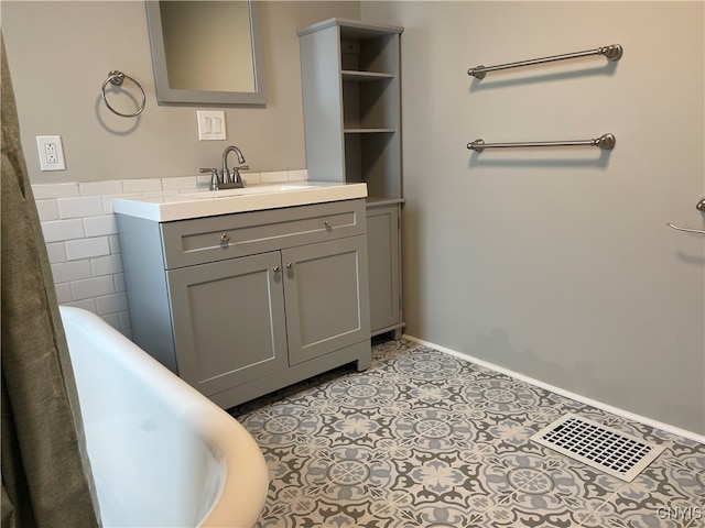 bathroom with tile walls, tile patterned flooring, a bathtub, and vanity