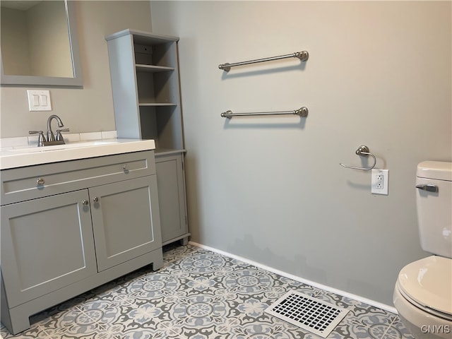 bathroom featuring tile patterned flooring, vanity, and toilet