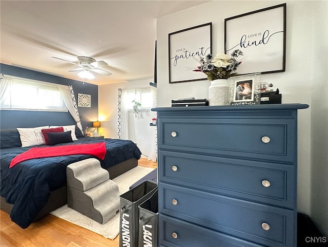 bedroom with light hardwood / wood-style floors and ceiling fan