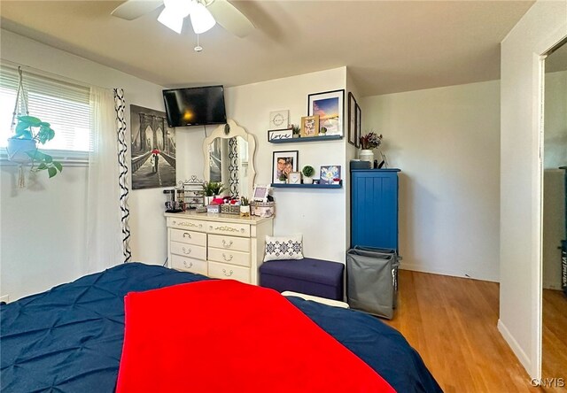 bedroom with light hardwood / wood-style floors and ceiling fan