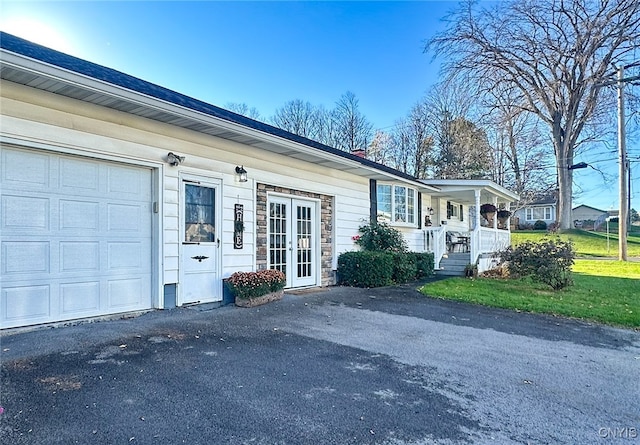 view of side of property featuring a garage and a porch