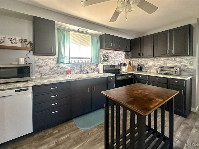 kitchen featuring light hardwood / wood-style flooring, tasteful backsplash, sink, and stainless steel appliances