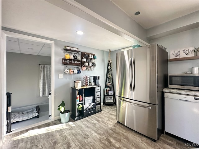 kitchen featuring light wood-type flooring and appliances with stainless steel finishes