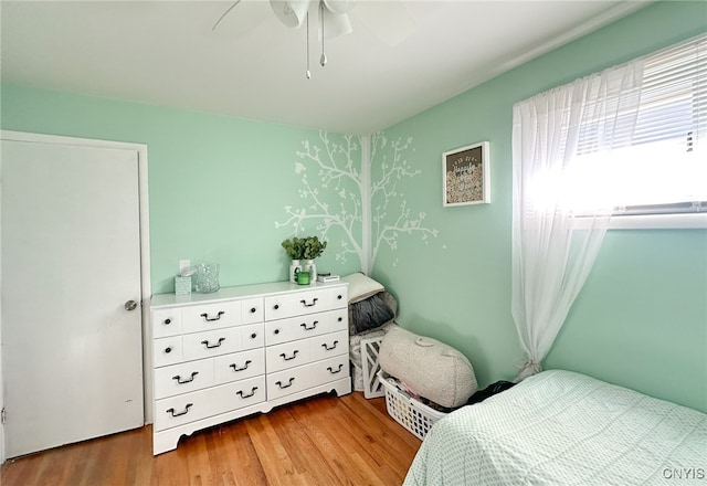 bedroom featuring hardwood / wood-style flooring and ceiling fan