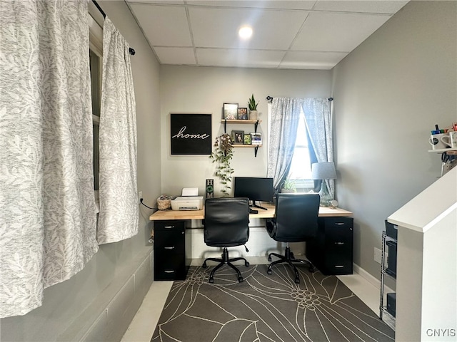 home office with a paneled ceiling