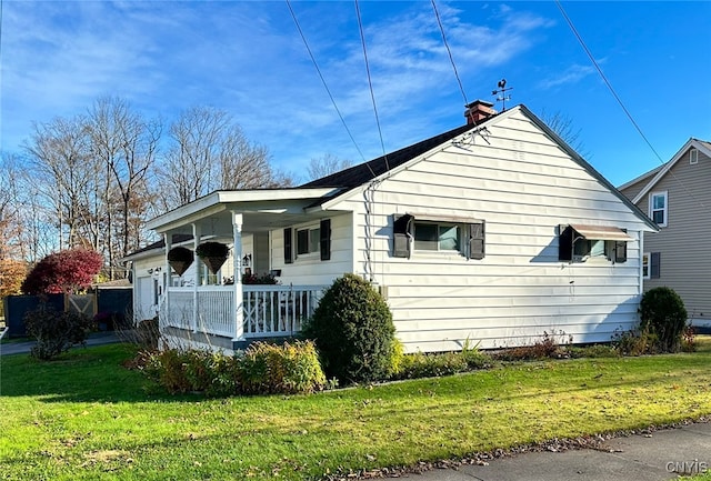 exterior space with a porch and a front yard