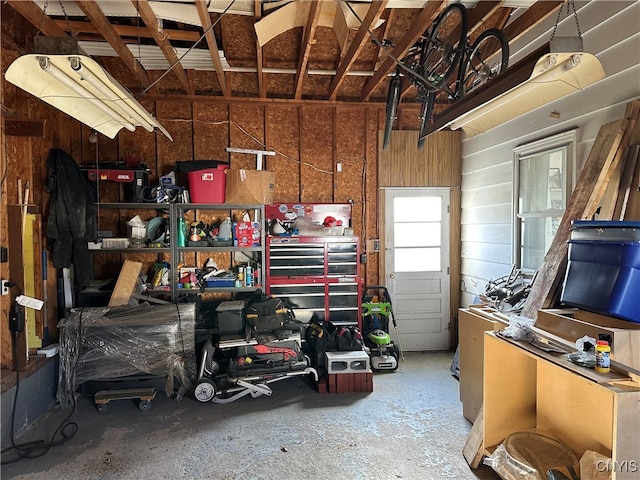 garage with wood walls and a workshop area