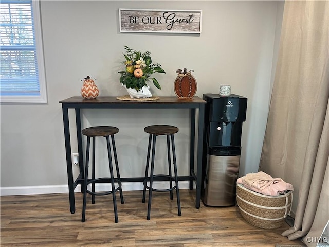 bar with hardwood / wood-style flooring