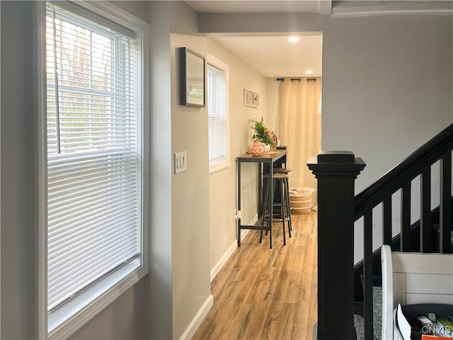 hallway with light hardwood / wood-style floors